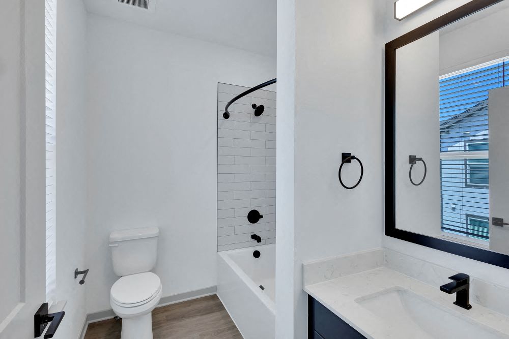 Secondary full bath with bathtub, sink and toilet